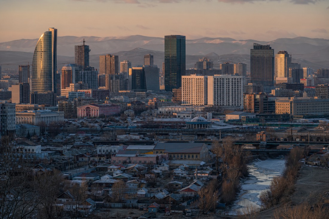 Ulaanbaatar's skyline of modern hotel buildings at dawn with quiet empty streets ready for an early pickup, no recognizable people or logos visible